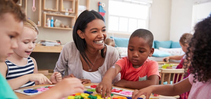 A teacher playing with students.